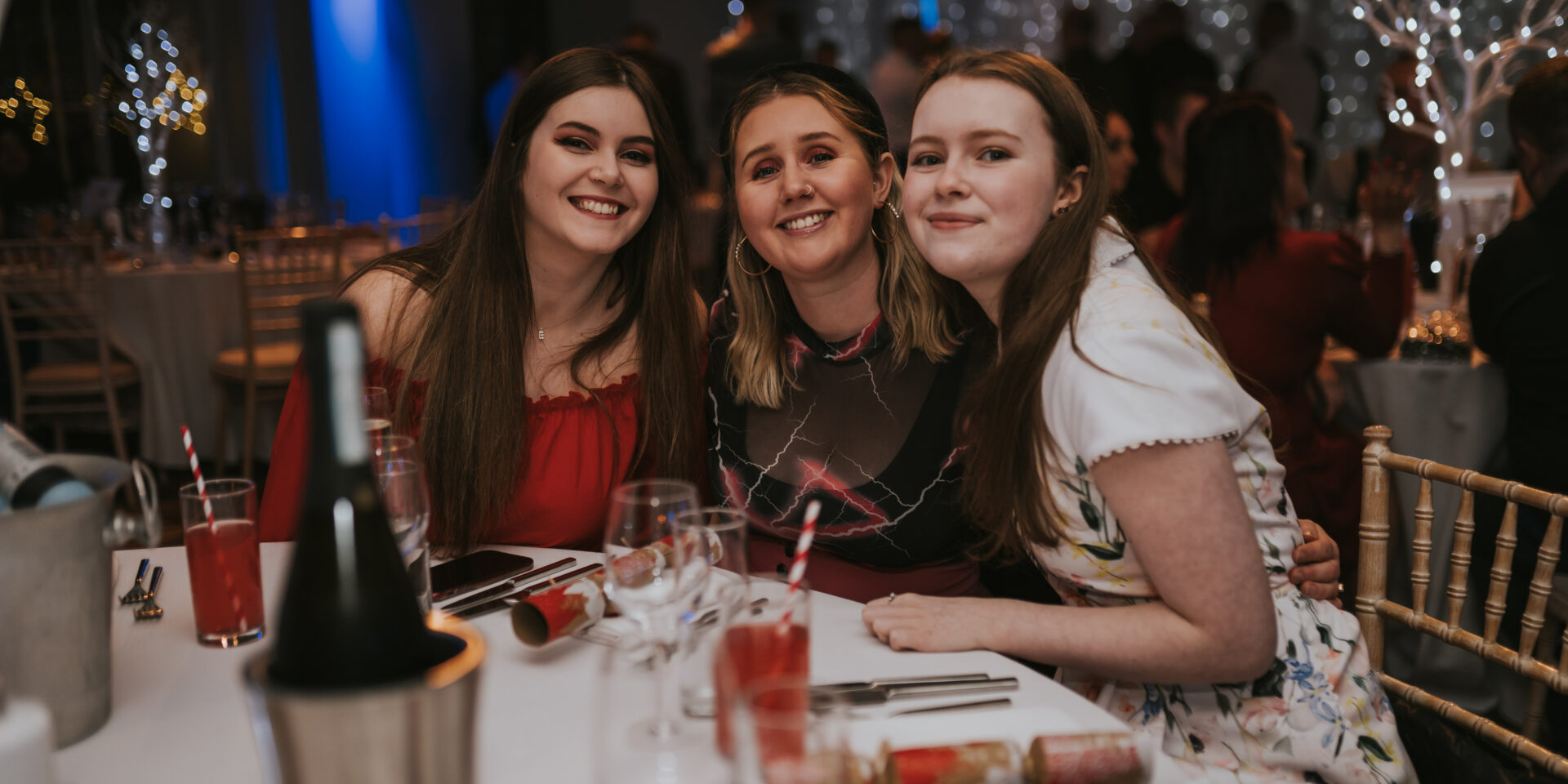 Three girls smiling at a Christmas party