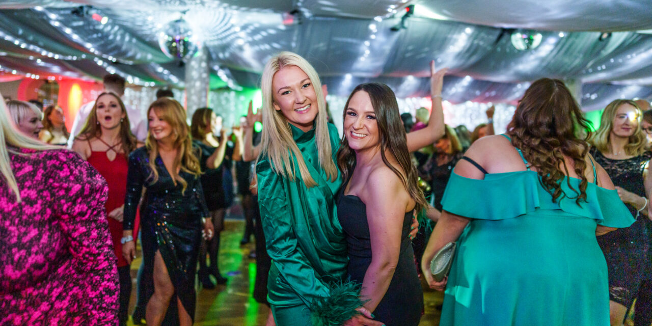 Two girls at a Christmas party smiling for the camera
