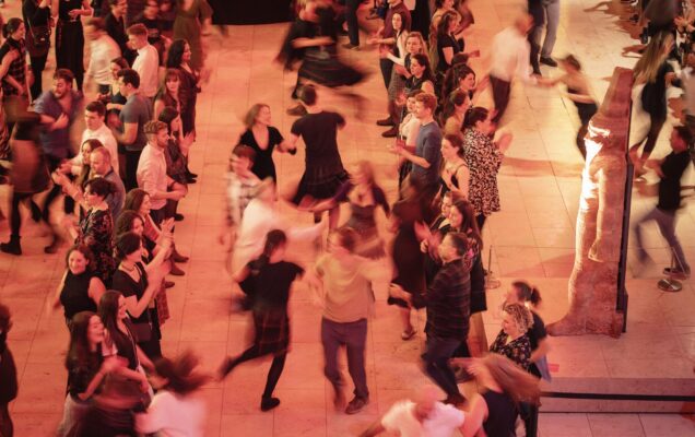 People ceilidh dancing at museum late at national museum of scotland