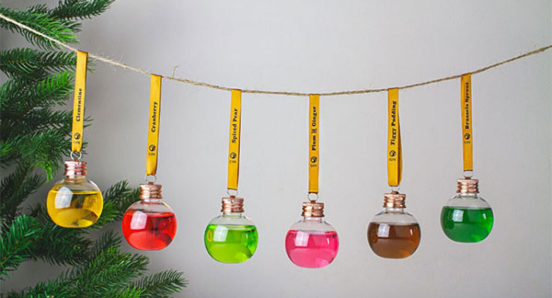 A string of glass baubles filled with different coloured gins.