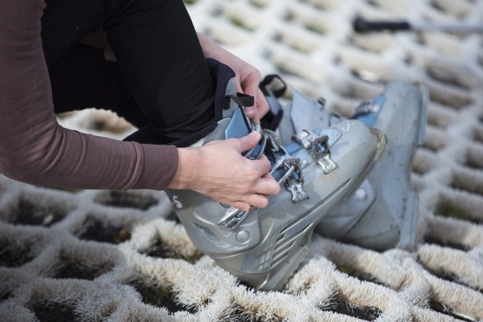 Person putting on Ski Boots on the dry ski slope