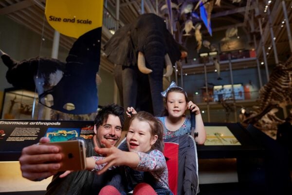 Father and two kids visiting the National Museum of Scotland
