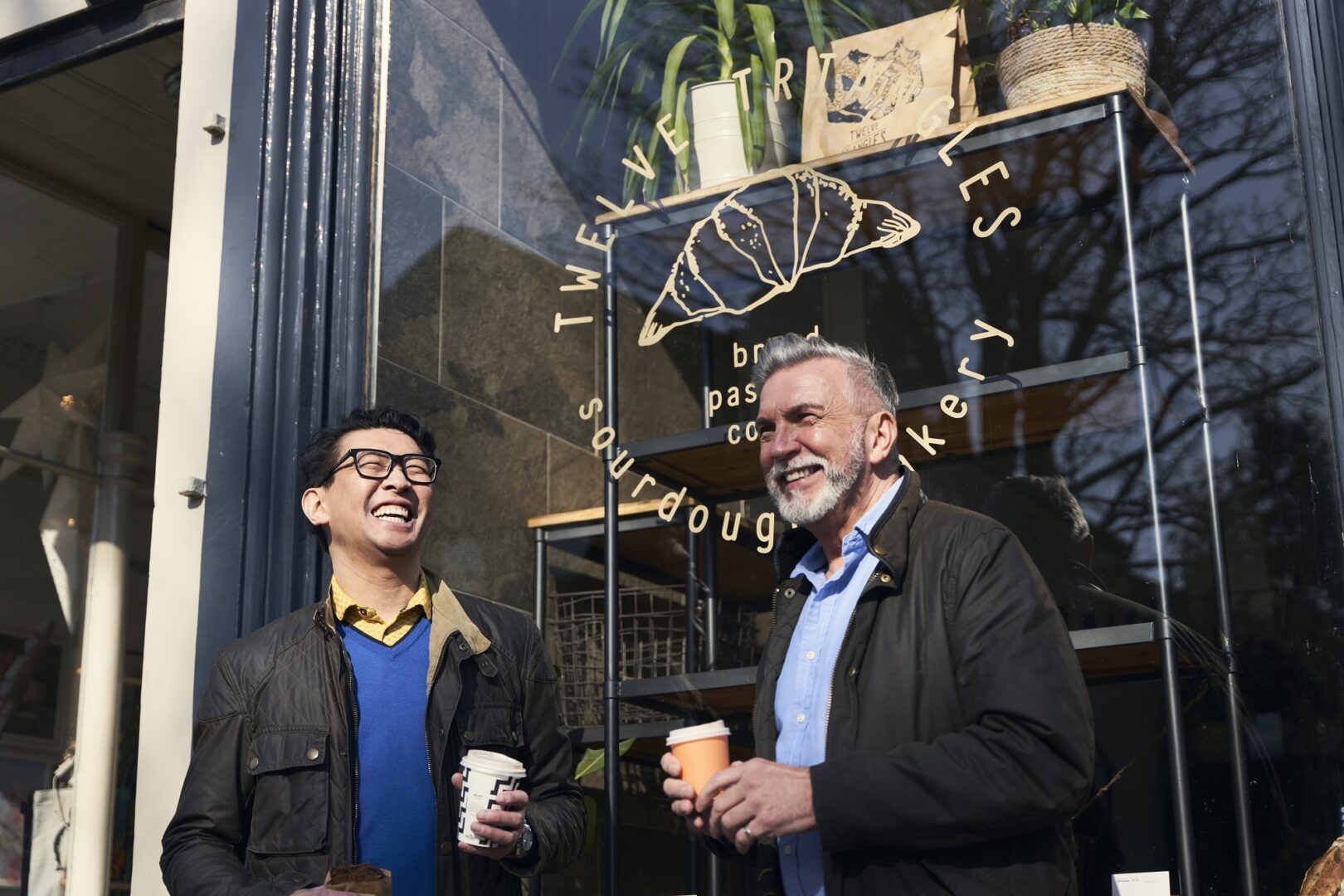 Two men enjoying a takeway coffee outside of Twelve Triangles bakery