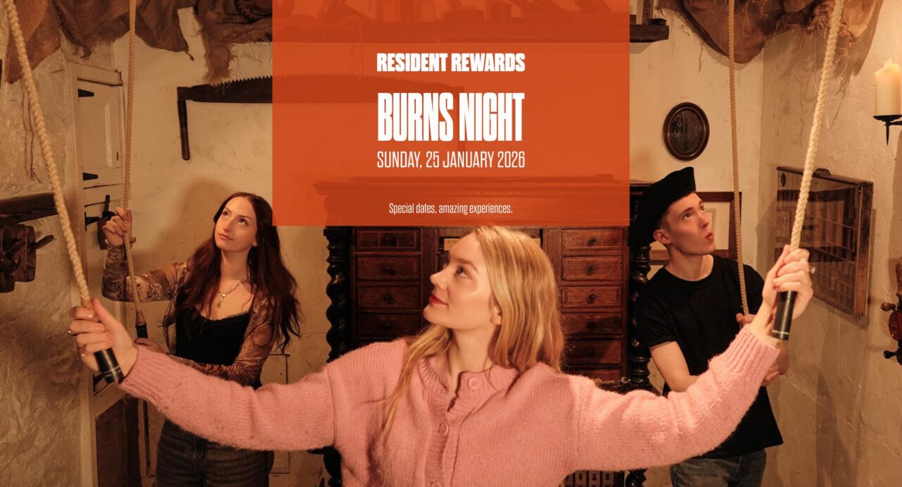 Orange box with words saying Rsidetn Reward Days Burns Night. Image behind is ofgroup taking part in escape room.