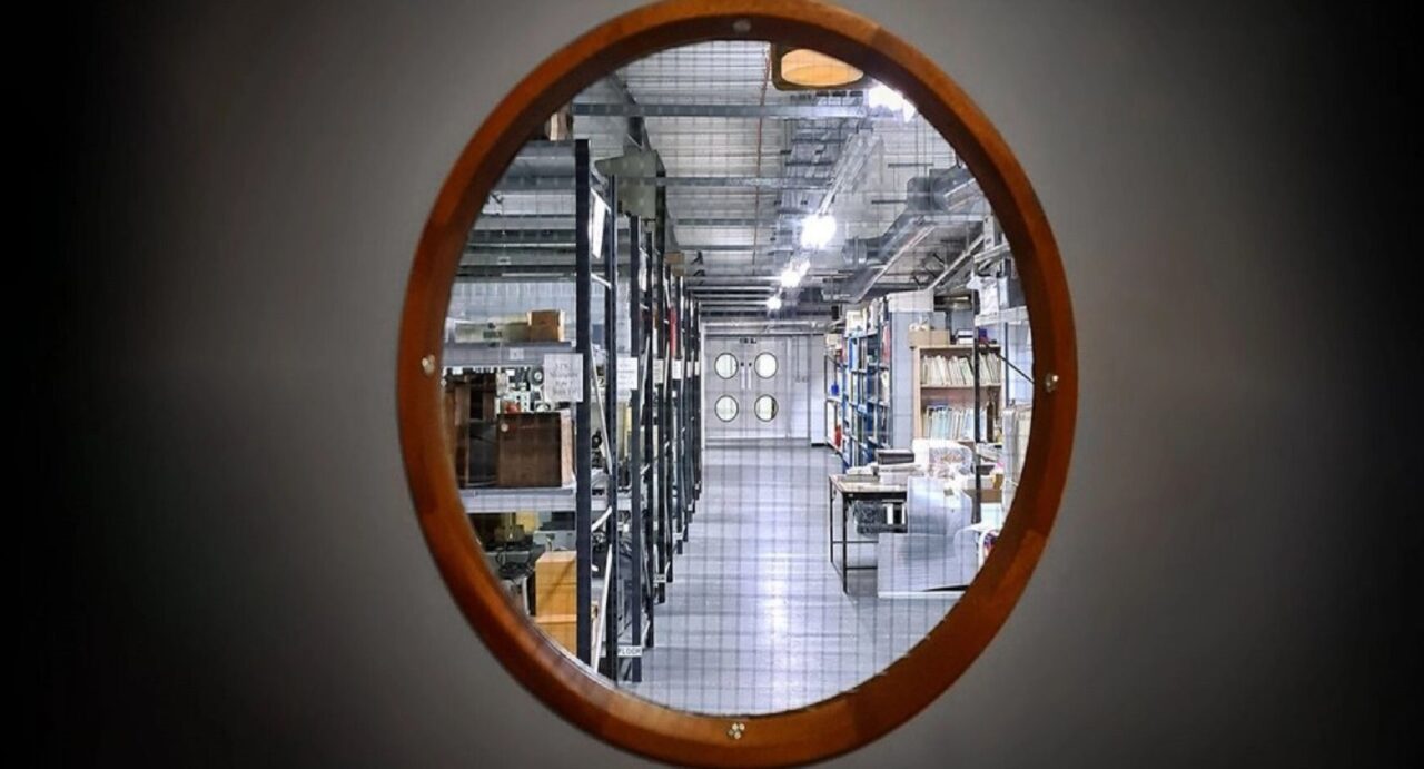 Circle window looking into a storage warehouse