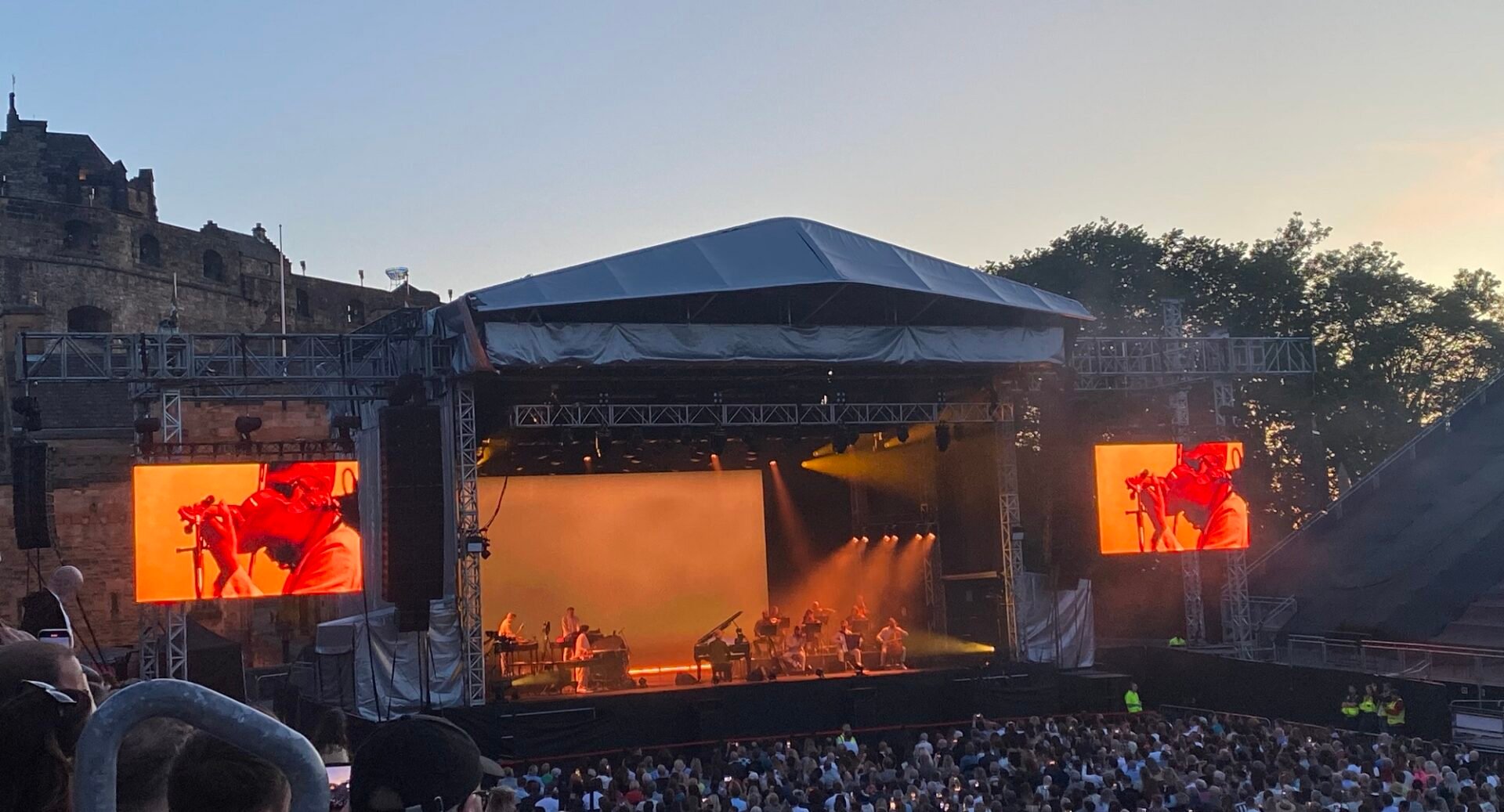 Concert at the Castle with stage, performaers, castle and audience