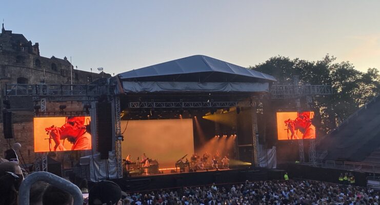 Concert at the Castle with stage, performaers, castle and audience