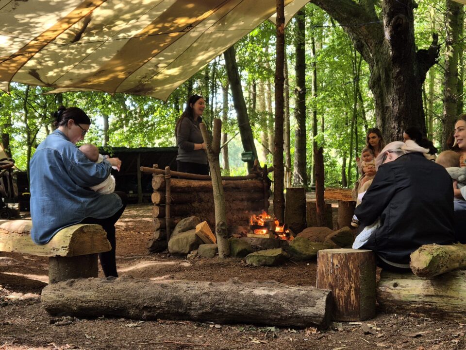 Parent and child group around campfire