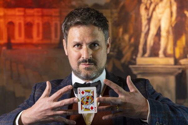 Magician holding a King of Diamonds Playing Card