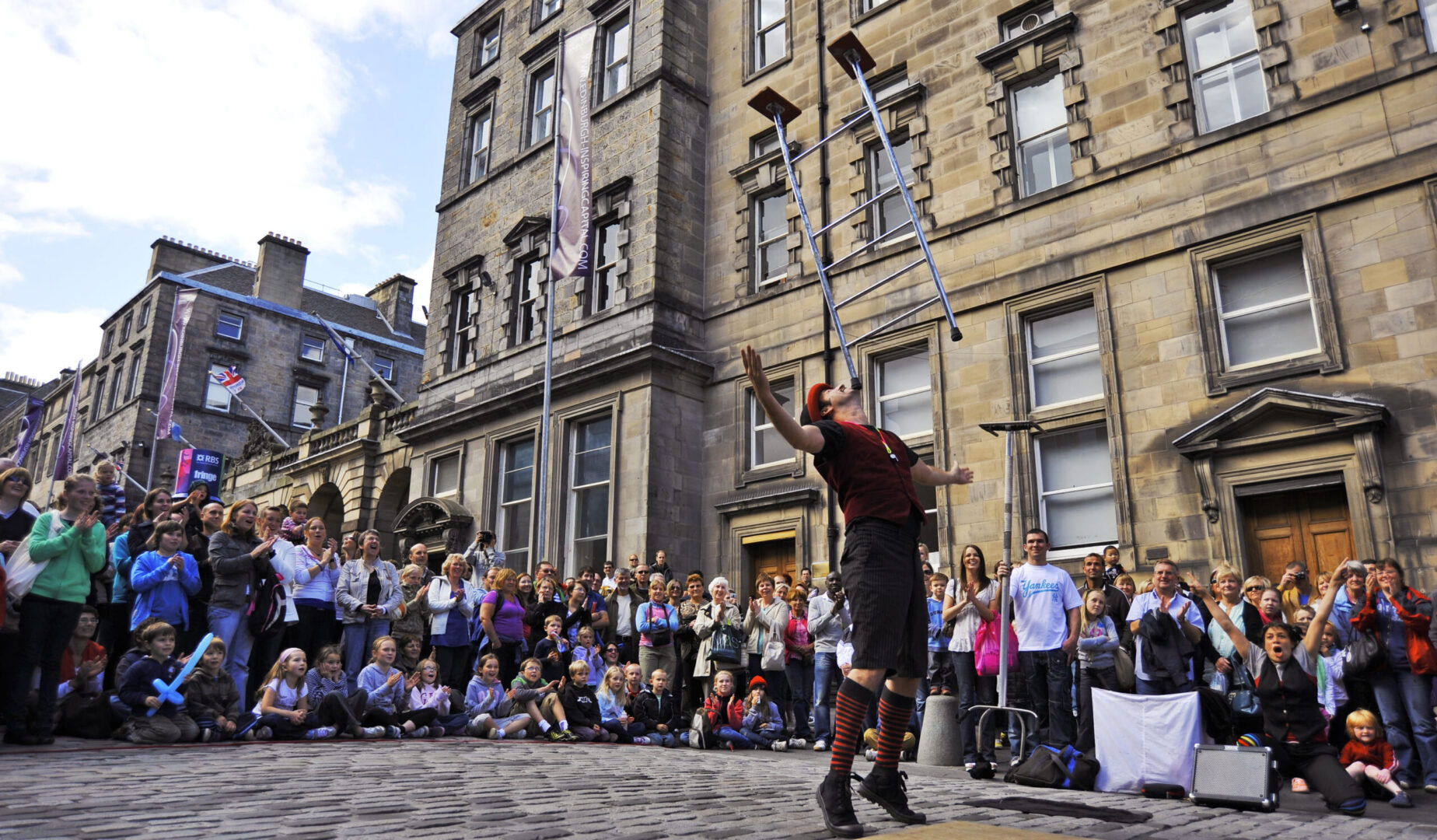 Edinburgh Street Performer on the Royal Mile with crowd watching during the Edinburgh Fringe Festival