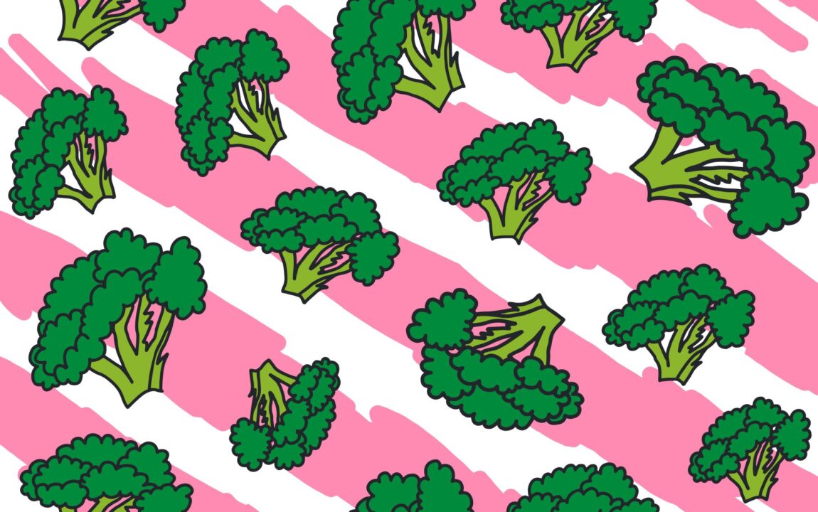 Green broccoli florets on a pink and white stripy background.