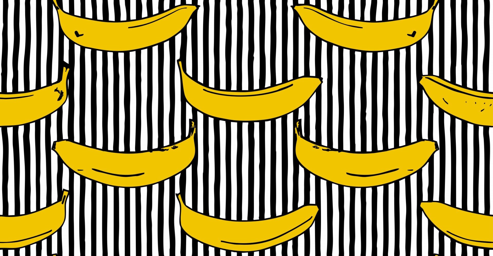 Yellow bananas on a black and white stripy background.