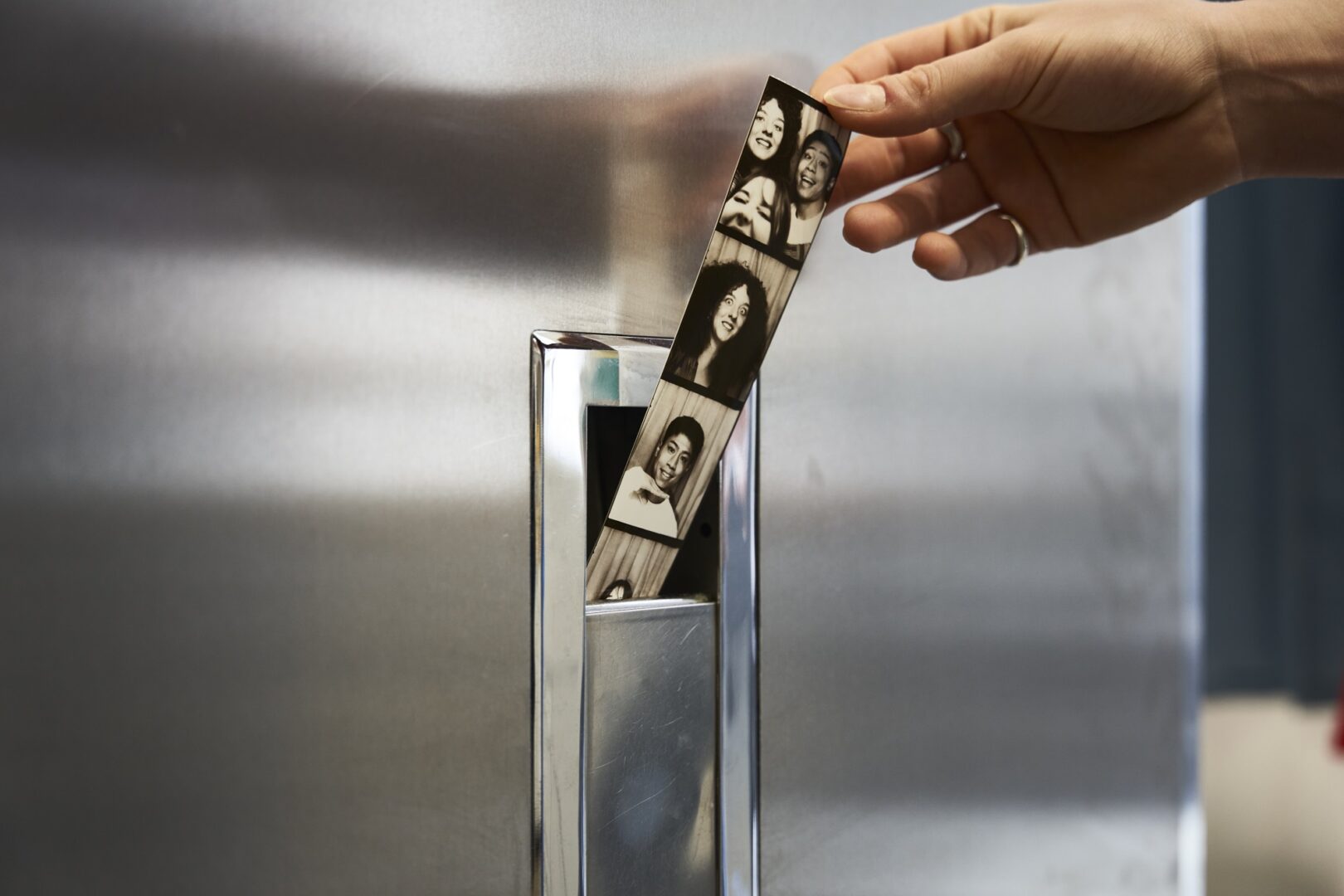 photos-being-grabbed-by-hand-from-photobooth