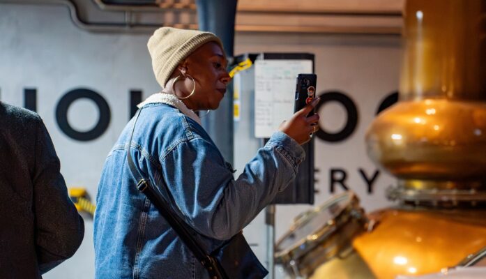 Lady looking at still at Holyrood Distillery