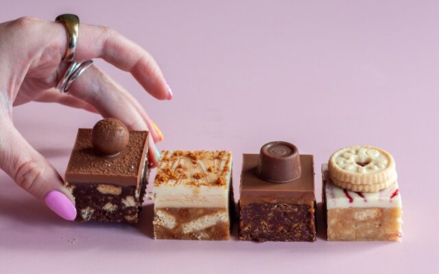 hand reaching out taking a mini traybake