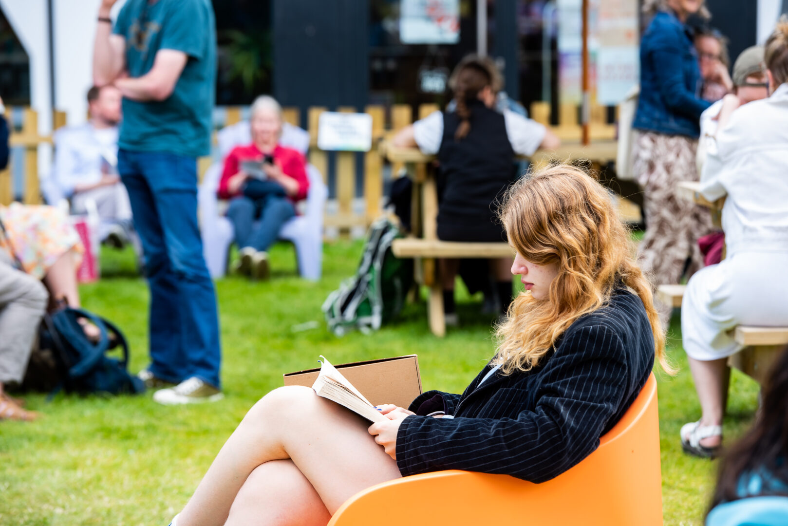 Woman sitting on a bean bag and reading a book