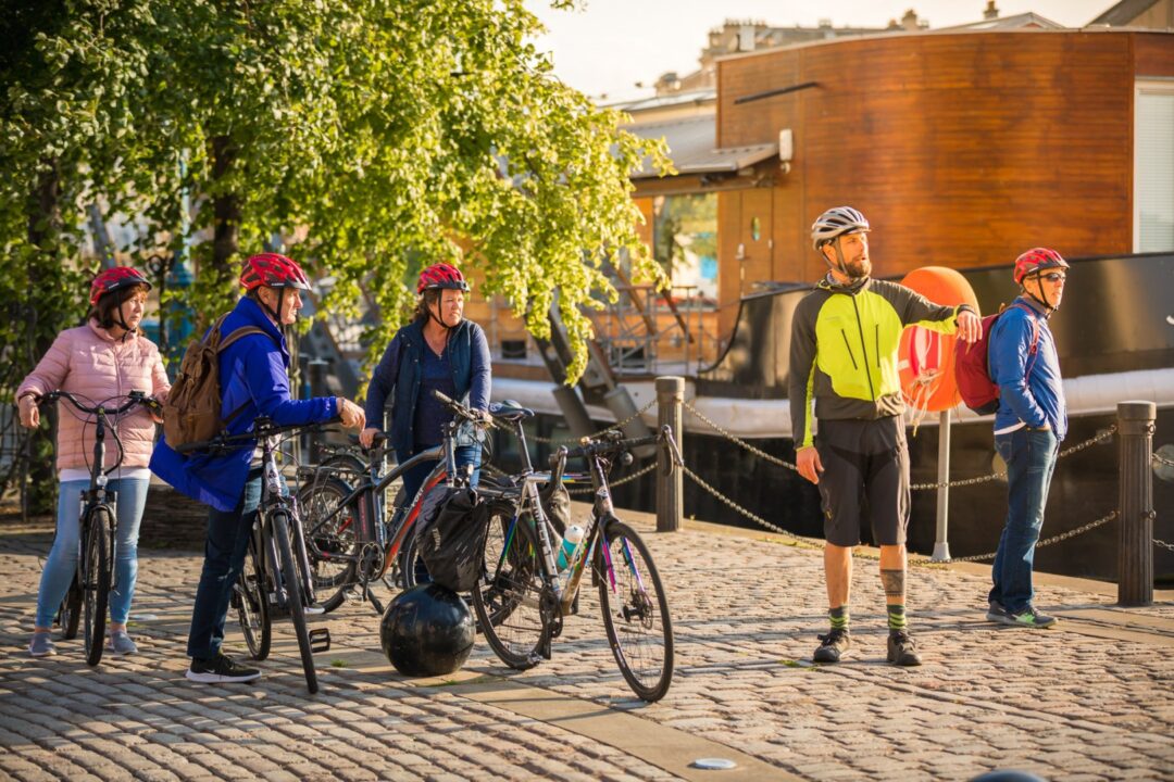 Two people on a bike tour with a tour guide.