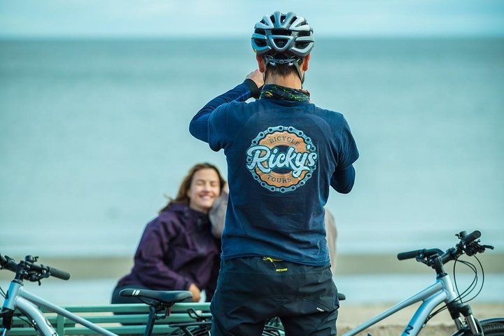 Ricky's Bicycle Tours tour guide taking a photo of tourists.