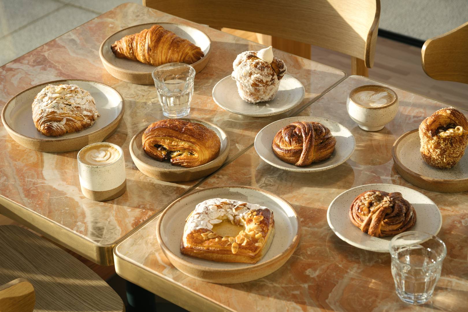 A table abundantly full of  crafted pastries and masterful coffee served in our own crafted pottery,© Patina Edinburgh