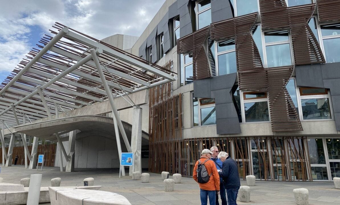 The Scottish Parliament with people looking at map