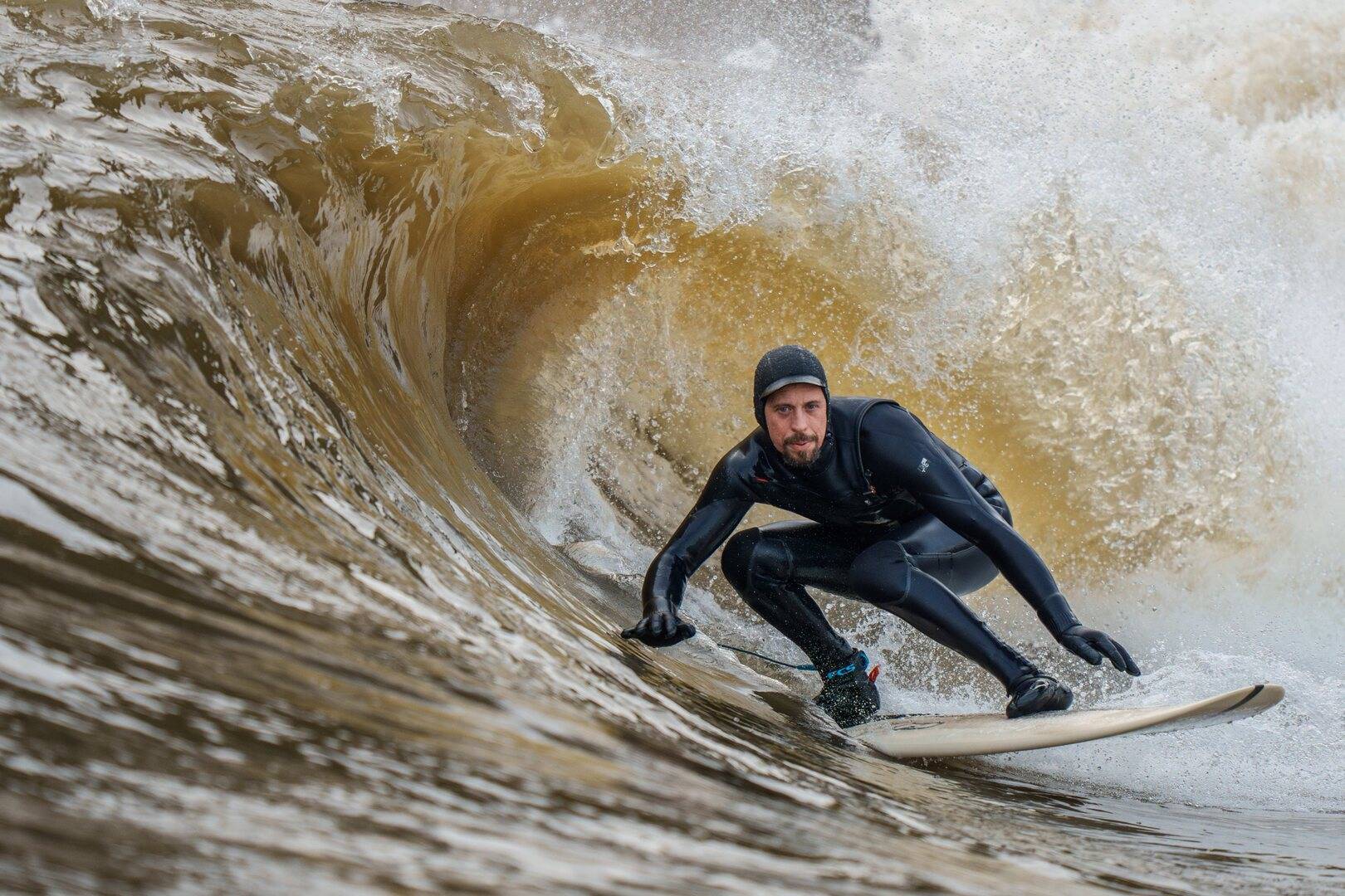 surfer riding a wave,© Lost Shore Surf Resort