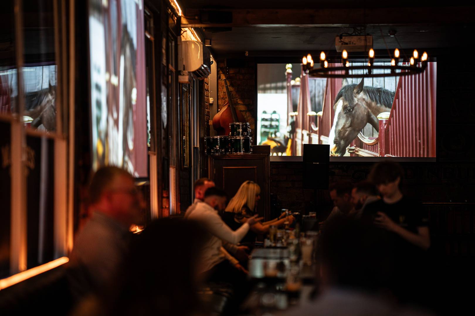 2 large screens on the wall in the pub showing the Cheltenham Festival,© Malones Edinburgh