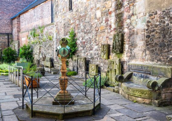 Courtyard garden with old stone benches and greenery