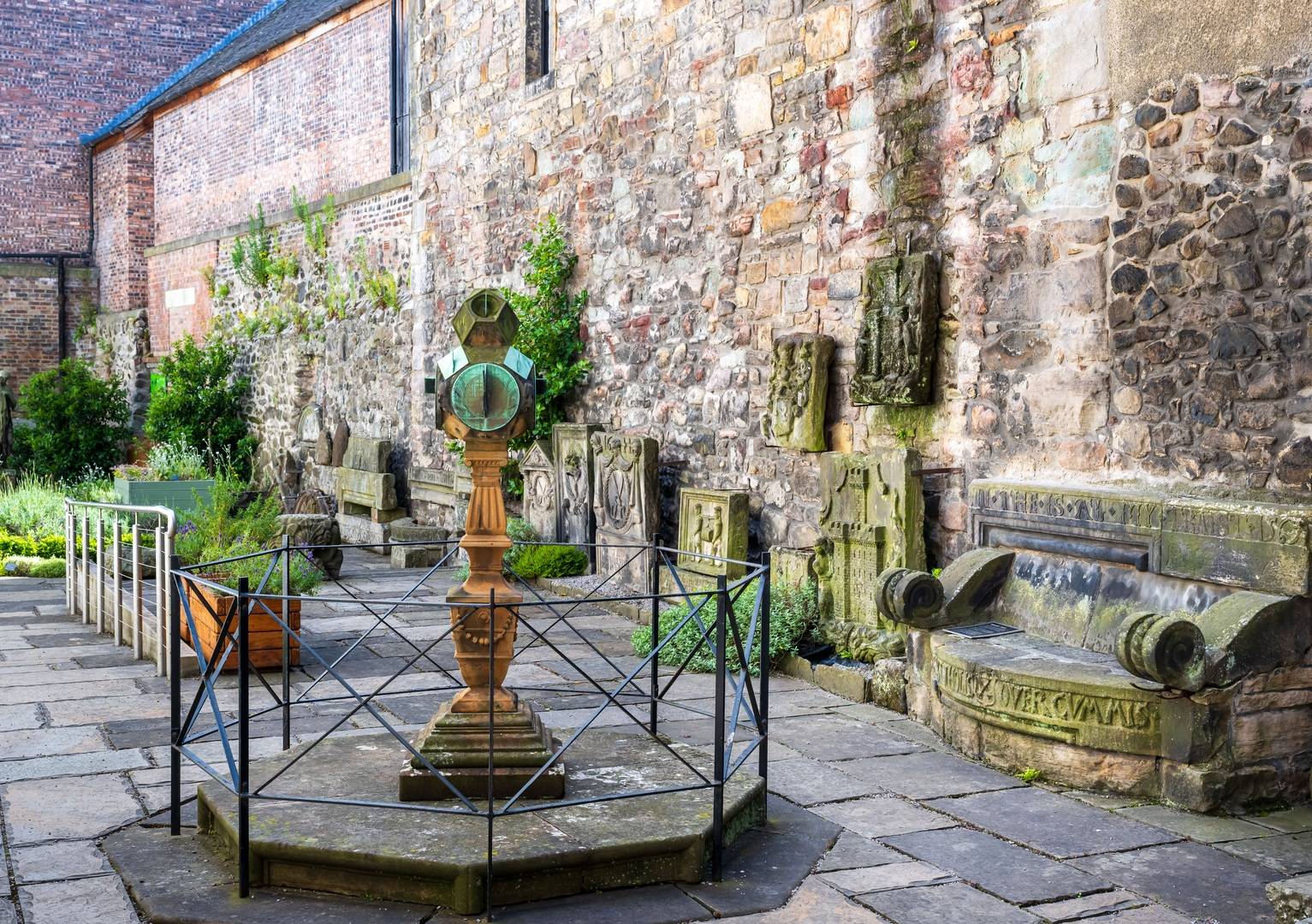 Courtyard garden with old stone benches and greenery